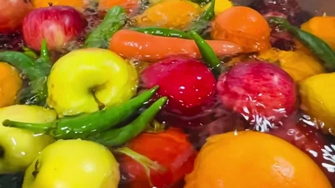 Dropping Mixed Fruits and Vegetables into Water Close-up Slow Motion Stock Footage 338205481