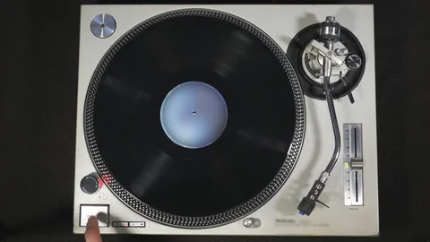 Dropping The Needle On The Record And Pressing Start, Overhead View Stock Footage 101424001