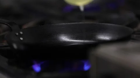Dropping oil in a cooking pan Stock Footage 133207089
