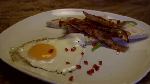 Dropping piece of red and green peppers on food plate. Video stock 131979807