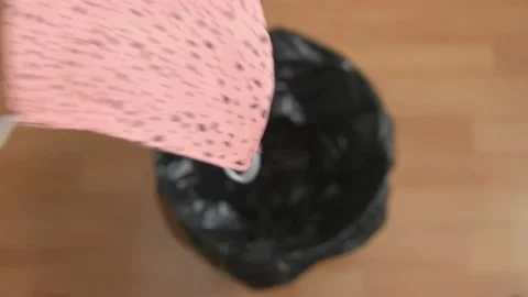 Dropping Pink Fabric Mask In Bin Slow Motion Stock Footage 157172927