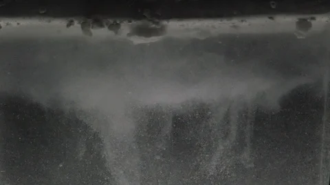 Dropping powder into the water Stock Footage 101599187