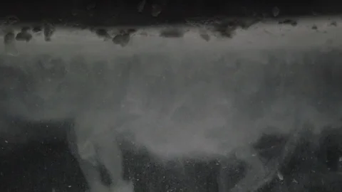 Dropping powder into the water Stock Footage 101602662