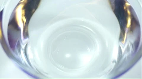 Dropping purple ink into plain water Stock Footage 50152849