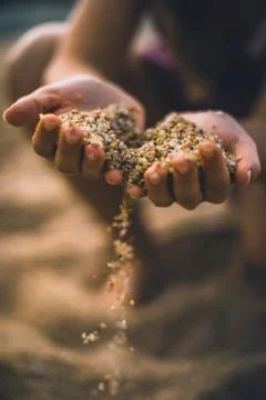 Dropping sand from both hands Stock Photos