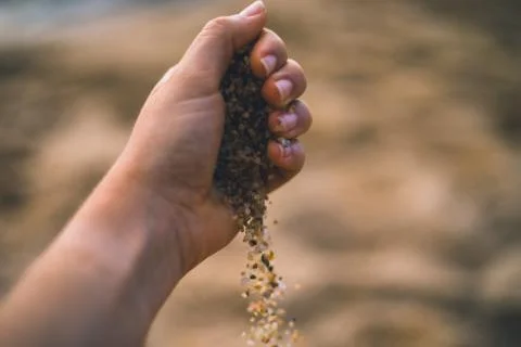 Dropping sand from hand Stock Photos