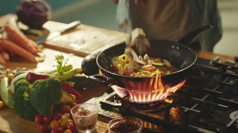 Dropping sliced vegetables in frying pan Stock-Footage 311835162