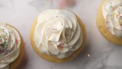 Dropping sprinkles on cupcake slow motion HD120p Stock-Footage 157992554