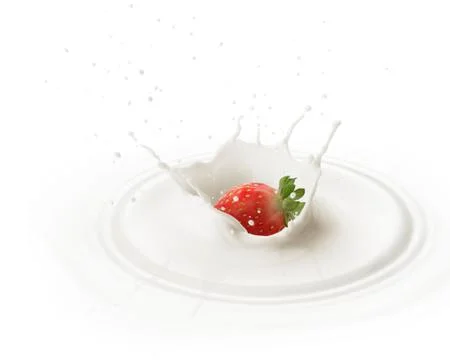 Dropping strawberry into milk Stock Photos
