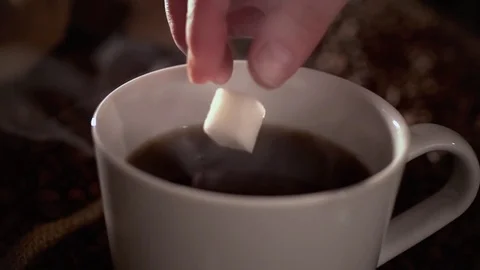 Dropping sugar in a coffee in slow motion Stock Footage 76100814