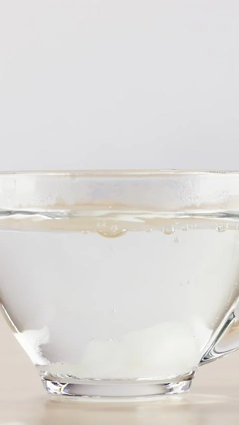 Dropping Sugar Cube into Glass Cup of Hot Water Stock Footage 346267603