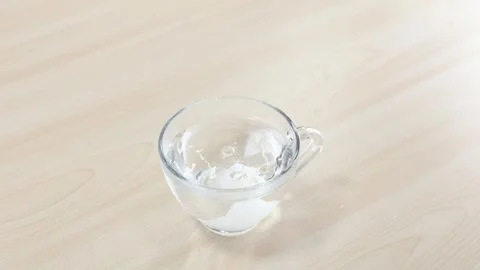 Dropping Sugar Cube into Glass Cup with Metal Tongs 스톡 동영상 347054228