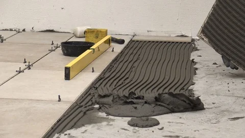 Dropping a tiles in adhesive Stock Footage 111866845