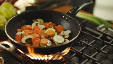 Dropping vegetable slices into the pan Stock Footage 311835275