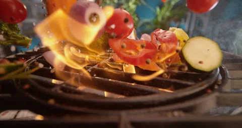 Dropping vegetables on grill Stock Footage 311832443