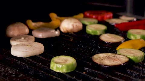 Dropping vegetables on a hot grill in slow motion Stock Footage 130786867
