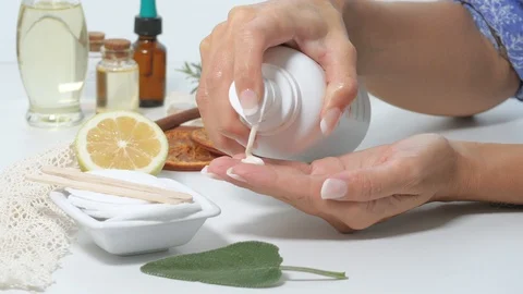 Dropping white cream on open hand Stock Footage 117429291