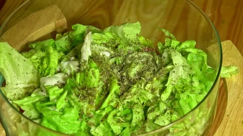 Dropping yogurt over  vegetarian salad by woman hand in home kitchen Stock Footage 231897152