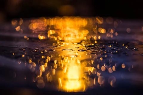 Drops after rain on the table after sunset Stock Photos