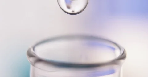 Drops are falling into test tube close up Stock Footage 75003112