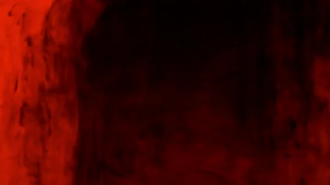 Drops of black ink diffusing into an orange liquid Stock Footage 201334710