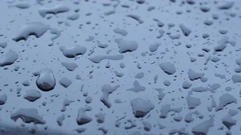 Drops on a black metal surface Stock Footage 177503835