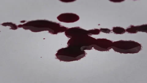 Drops of Blood Fall on White Paper in Macro Stock Footage 201223157