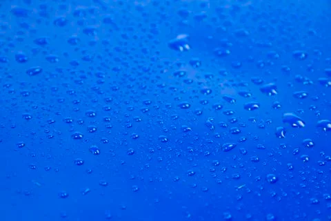 Drops on blue background Stock Photos