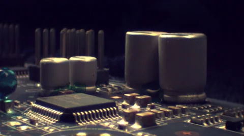 Drops of blue liquid bounce off electronic circuits. ECU. Slow motion. Stock Footage 64879089