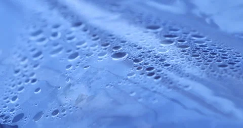 Drops on Blue Sheet Stock Footage 320417552