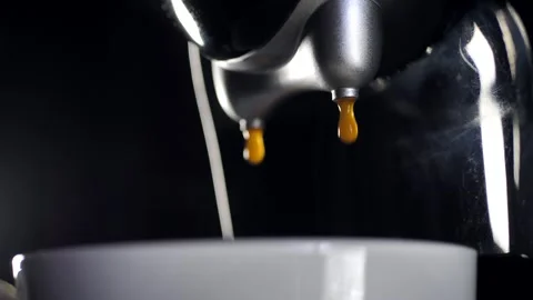 Drops of brewed coffee drip into a cup. Drip coffee maker in action Stock Footage 273831393