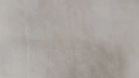 Drops of brown liquid fall on the white material. Stock Footage 116956692