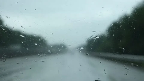 Drops on the car window on the road. The road on rainy day. Stock Footage 233847558
