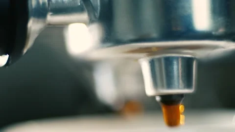 Drops of coffee drip from the coffee machine into the cup, making coffee. Stock Footage 171540011
