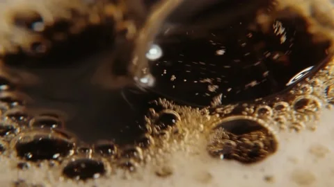 Drops of coffee fall into the glass, coffee foam. Slow motion in macro. Stock Footage 137858325