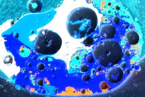 Drops of colored paint in milk in a macro shot Stock Photos