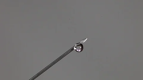Drops of colorless liquid flow Stock-Footage 122976604