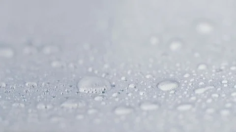 Drops of crystal clear water on the horizontal surface. Pattern of rain drops on 動画素材 84827678