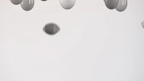 Drops of different colors fall down on a white background in a row. Stock Footage 130488303