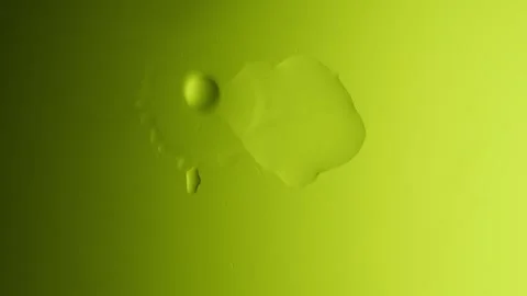 Drops drip from above and scatter across a yellow gradient background 스톡 동영상 303061019