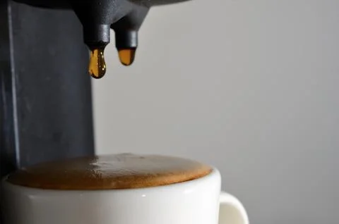 Drops of espresso and coffee machine Stock Photos