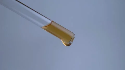 Drops Of Essence Fall From A Pipette In Macro Light Background Stock Footage 153119643