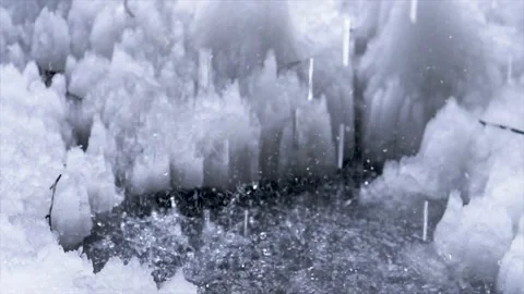 Drops fall into the melted ice. High quality 4k footage Stock Footage 172779146