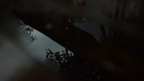 Drops fall in a puddle that reflects the cornice of the building Stock Footage 122220247