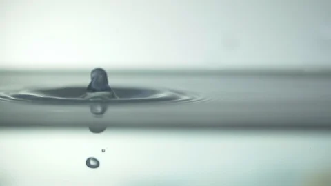 Drops fall into the water and the circles diverge from them Stock Footage 105237795