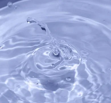 Drops fall into the water. beautiful background Stock Photos