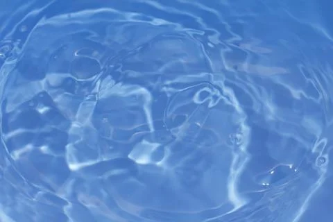 Drops fall into the water. beautiful background Stock Photos