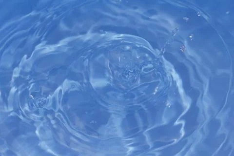 Drops fall into the water. beautiful background Stock Photos