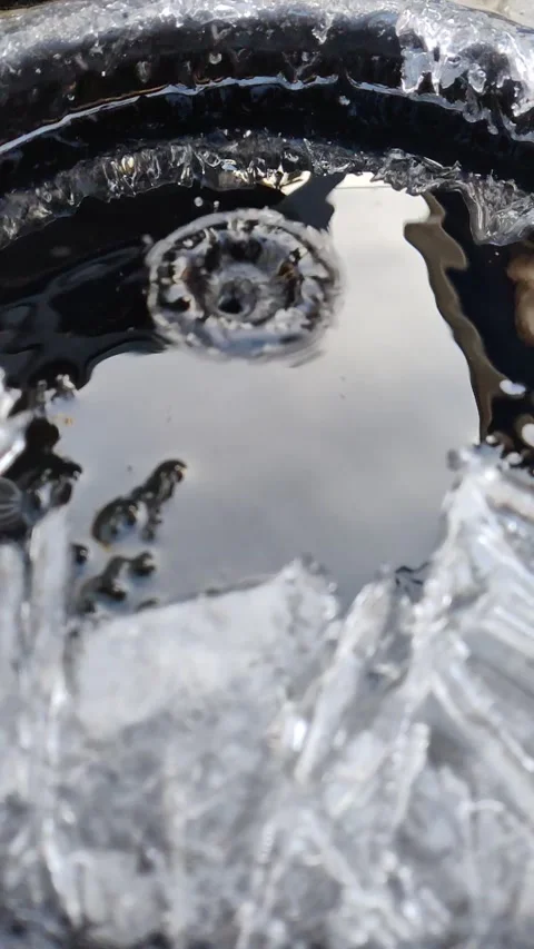 Drops fall into water with ice crystals. 1 Video stock 293929930