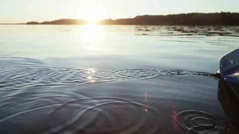 Drops fall on the water of lake due to the work of the kayak oar paddle in a Stock Footage 153289504